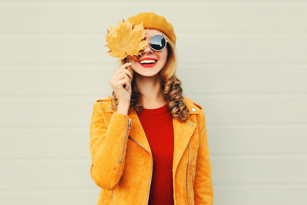 Woman holding a Leaf in Autumn Clothes