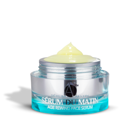 ANJALI MD Age Rewind Face Serum - One jar spilling out onto another on a pink background