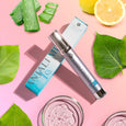 ANJALI MD Skincare - Adult Acne Clarifying Cleanser bottle leaning on box in front of a bunch of ingredients