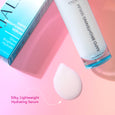 A closeup of ANJALI MD Skincare Rapid Brightening Serum bottle, leaning on the box, with a smear that depicts the serum texture and a text caption: Silky, Lightweight Hydrating Serum