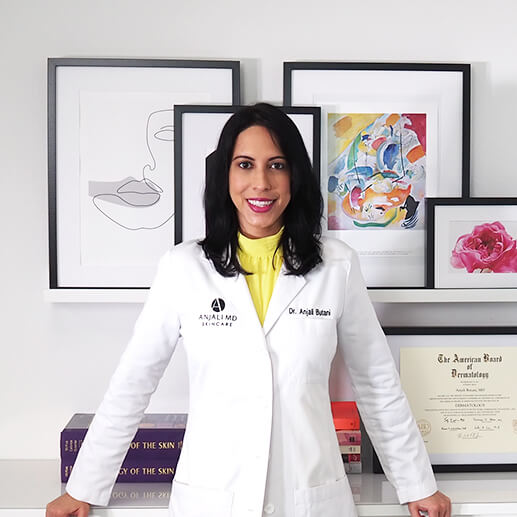 Dr. Anjali Butani in a yellow dress standing in her office