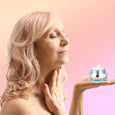 A woman applying Age Rewind Neck Cream