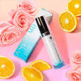 ANJALI MD Skincare Rapid Brightening Serum shown next to roses and oranges, ingredients used in the formula